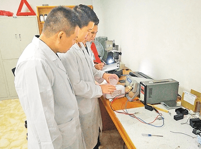 研究人員正在向應(yīng)急燈電池盒內(nèi)灌入鹽水